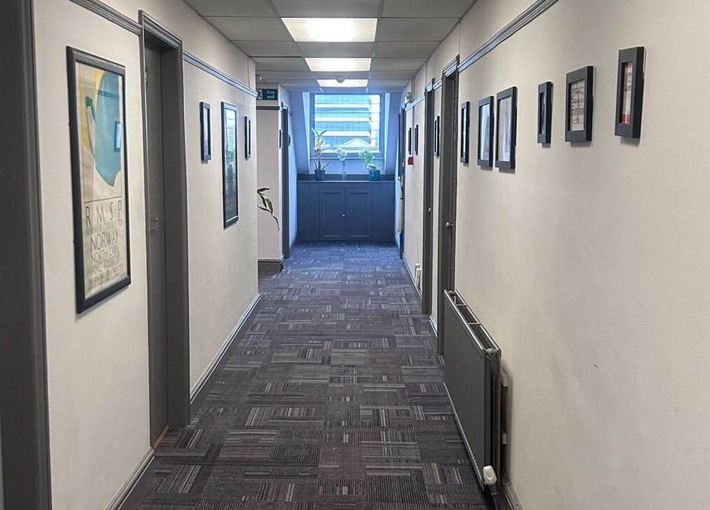 Elegant hallway at Wellness by Mariana, Southampton, England, GB, with framed art and soft lighting.