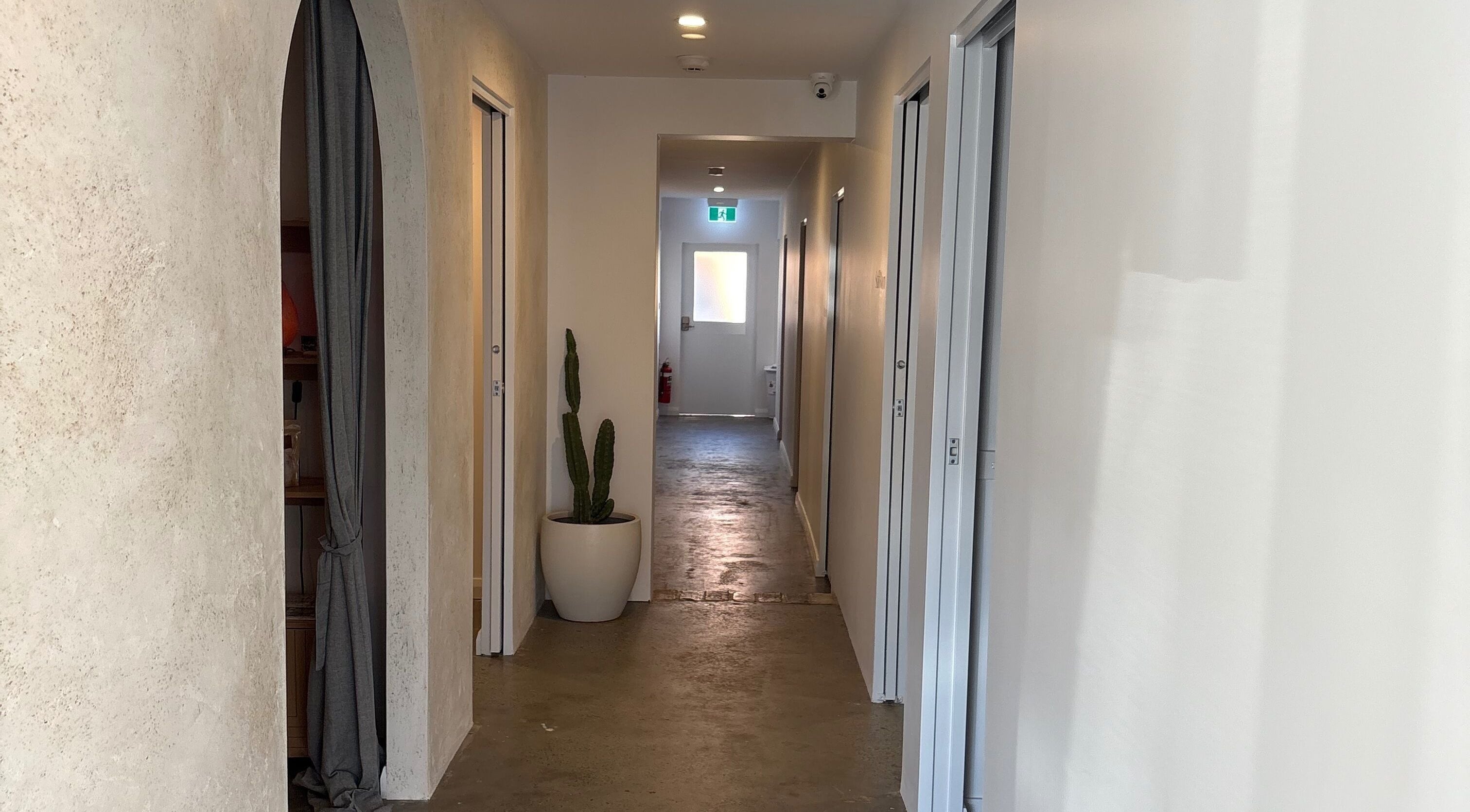 Serene hallway at Gallanu, Nelson Bay, New South Wales, AU with a minimalist design and a potted cactus.
