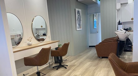 Modern salon interior at Hair Junkie in Toowoon Bay, New South Wales, AU with stylish chairs and mirrors.