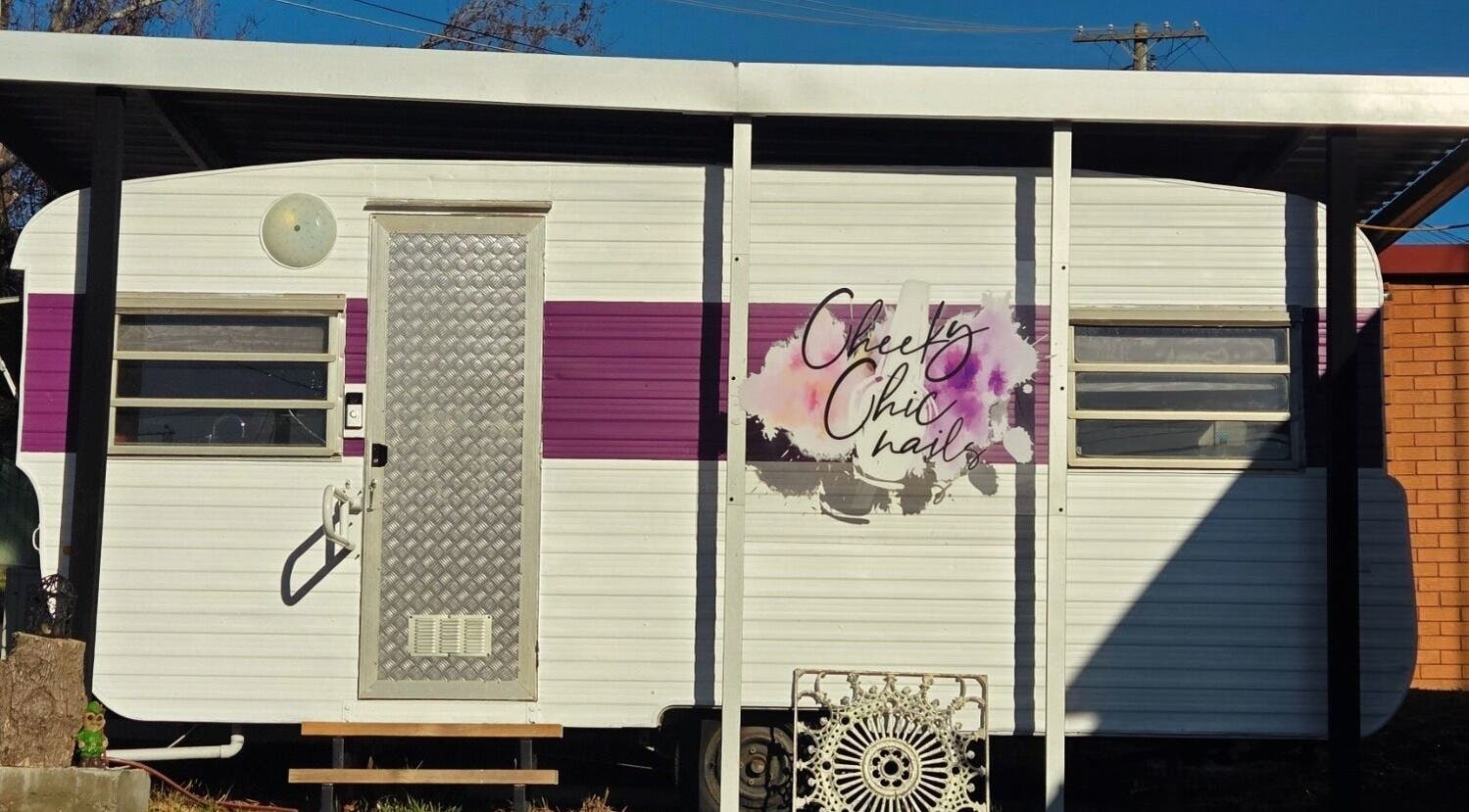 Entrance of Cheeky Chic Nails at Emu Plains, New South Wales, AU, featuring a stylish caravan design.