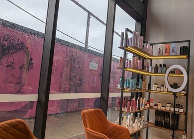 Product shelves and seating in Bibi Beauty, Erskineville, New South Wales, AU, with rain-dotted windows.