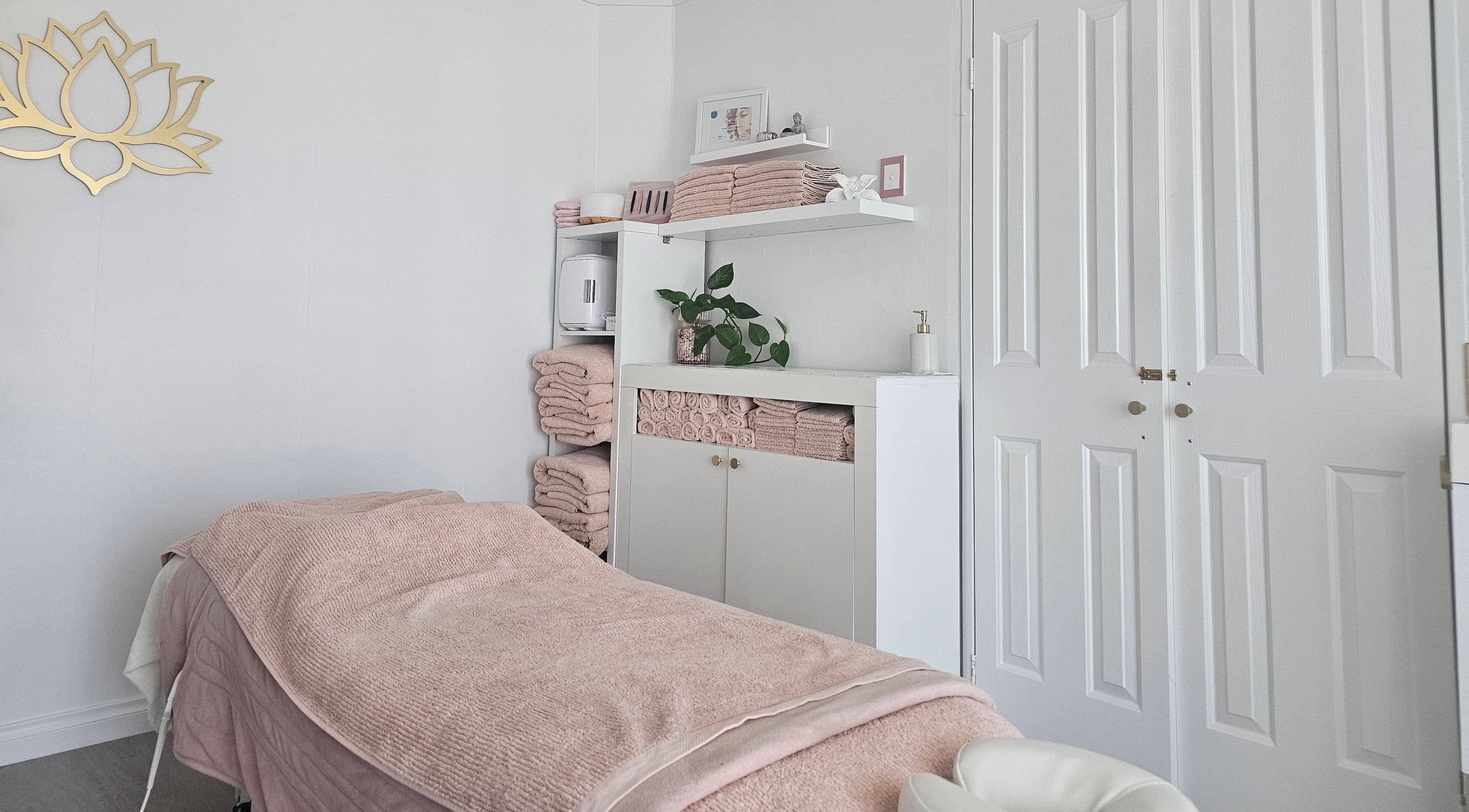 Relaxing treatment room at Zen Spa & Beauty in Secret Harbour, Western Australia, AU, with soft pink decor.