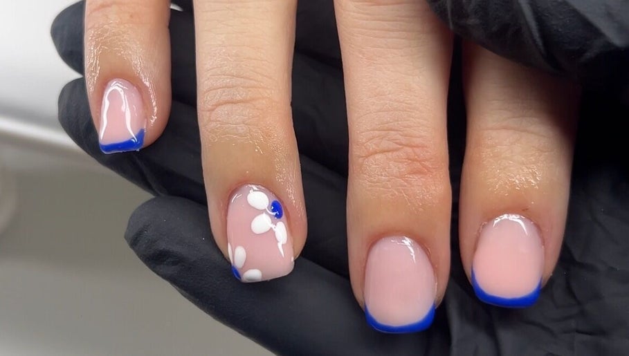 Elegant floral nail art with blue tips at Bialana, Ramsgate Beach, New South Wales, AU.