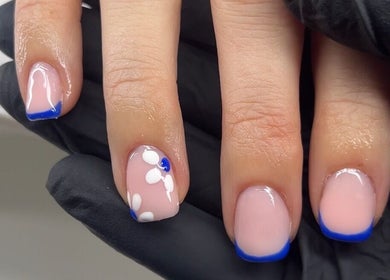 Elegant floral nail art with blue tips at Bialana, Ramsgate Beach, New South Wales, AU.