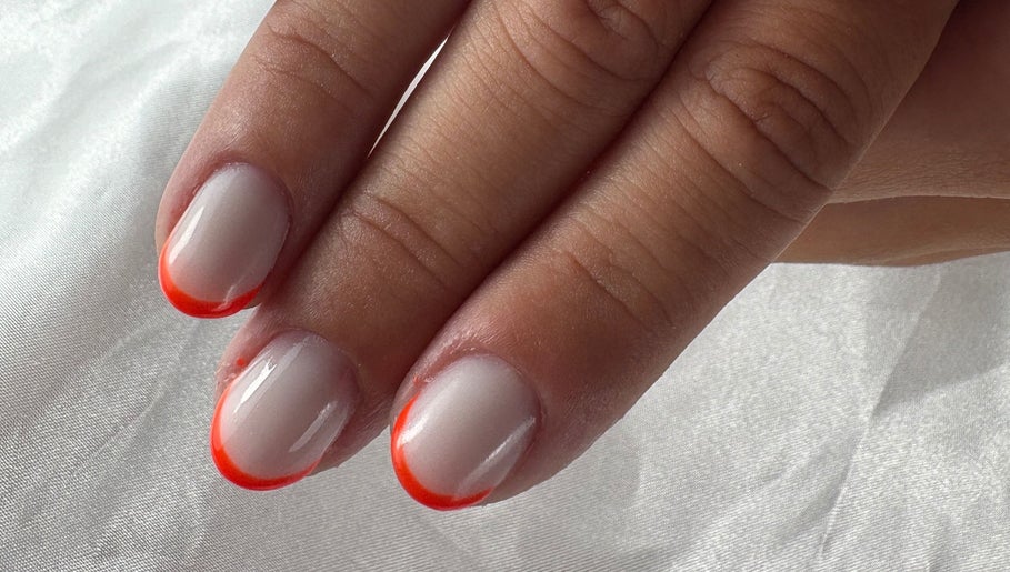 Vibrant orange-tipped nails from Nail Studio By M.C in Ombrée D'anjou, Pays De La Loire, FR.