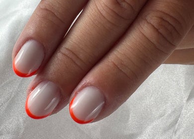 Vibrant orange-tipped nails from Nail Studio By M.C in Ombrée D'anjou, Pays De La Loire, FR.
