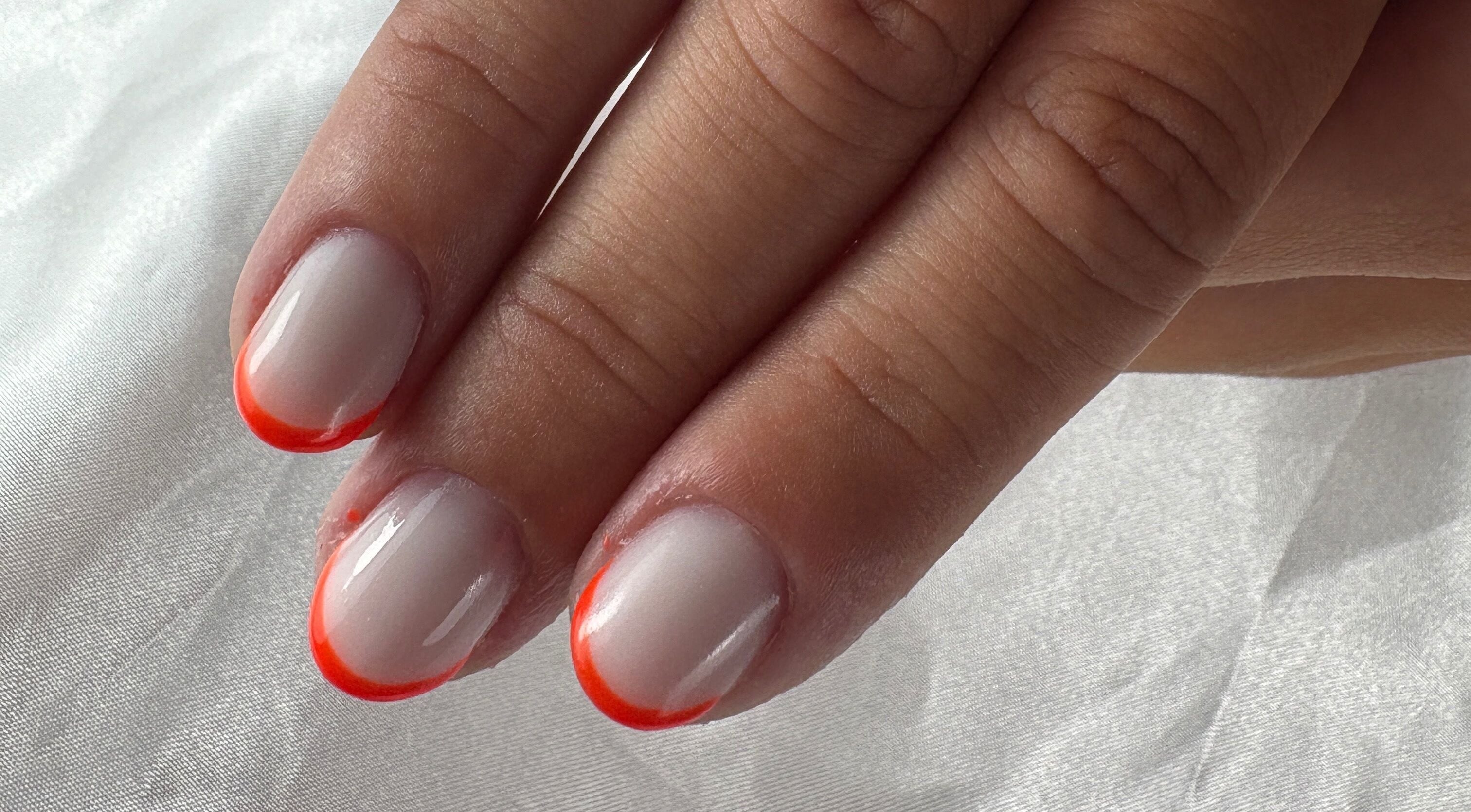 Vibrant orange-tipped nails from Nail Studio By M.C in Ombrée D'anjou, Pays De La Loire, FR.