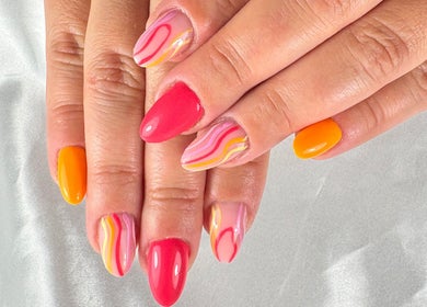 Colorful nail art at Nail Studio By M.C, Ombrée D'anjou, Pays De La Loire, FR, showcasing vivid orange and pink designs.