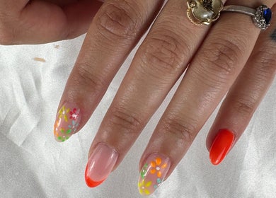 Floral and vibrant orange nail design at Nail Studio By M.C, Ombrée D'anjou, Pays De La Loire, FR.