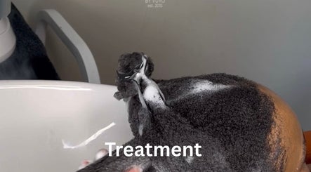 Client receiving a hair treatment at Braidsbyvuyo - Natural Hair Salon in Sandton, Gauteng, ZA. Relaxation and care.