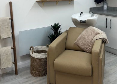 Relaxing salon chair at Grace Sadler Hair, Broughton Astley, England, GB. Brown tones with modern design.