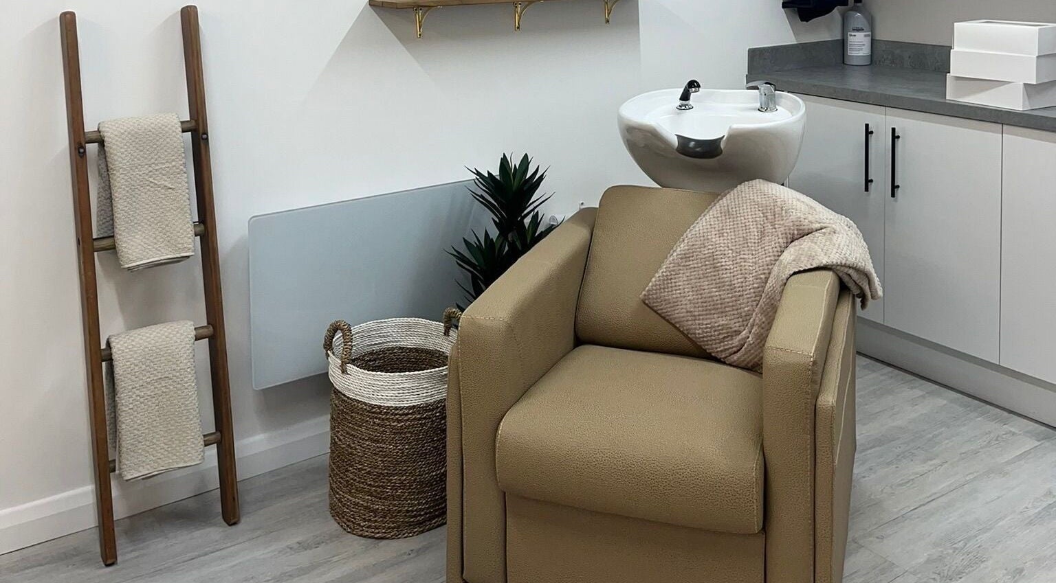 Relaxing salon chair at Grace Sadler Hair, Broughton Astley, England, GB. Brown tones with modern design.