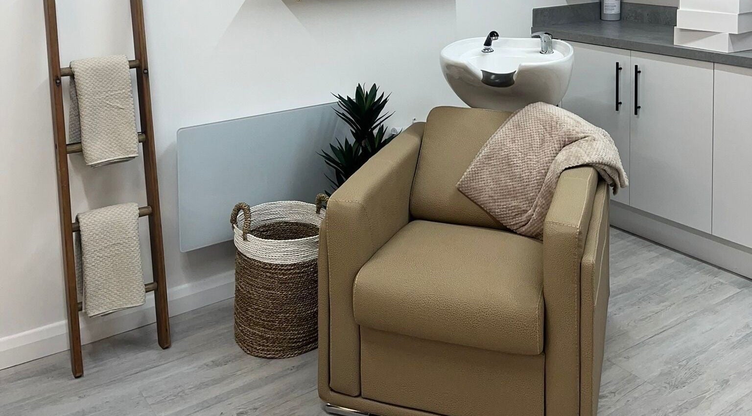 Elegant hair washing station at Grace Sadler Hair, Broughton Astley, England, GB with a modern, cozy setup.