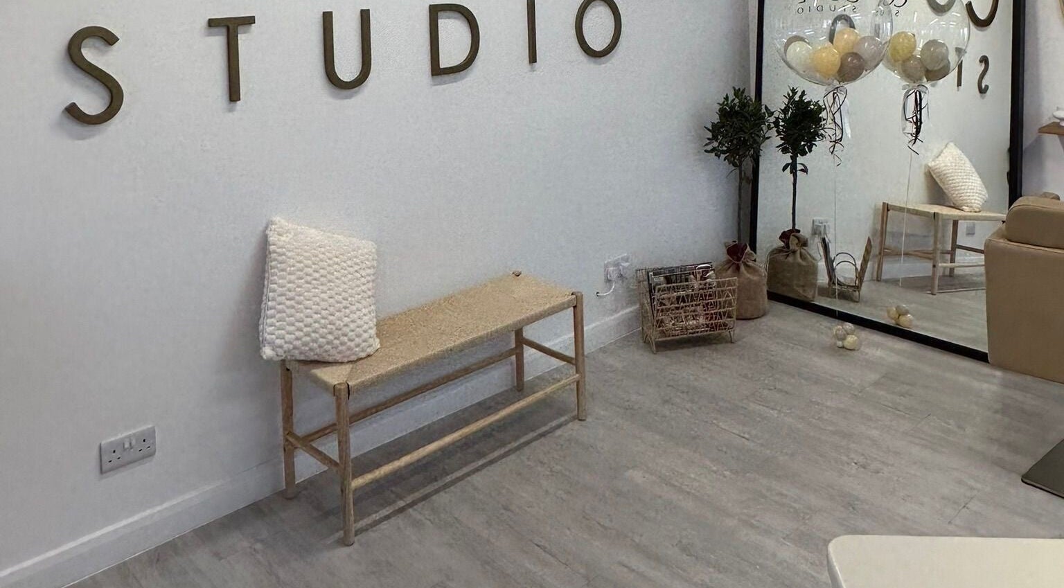 Modern studio interior at Grace Sadler Hair in Broughton Astley, England, GB. Minimalist decor with bench.