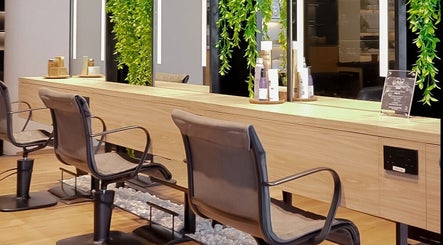 Modern salon chairs at Story 92 House of Beauty in Dubai, Dubai, AE with lush green decor and sleek design.