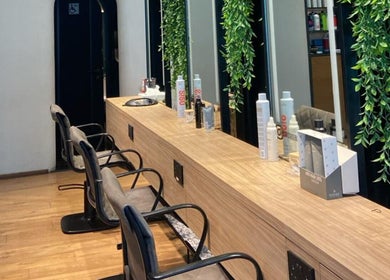Chic salon interior at Story 92 House of Beauty, Dubai, Dubai, AE with modern chairs and product display.