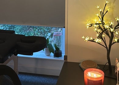 Peaceful treatment room at Mar Beauty, Canterbury, England, GB with ambient lighting and a cozy massage table.