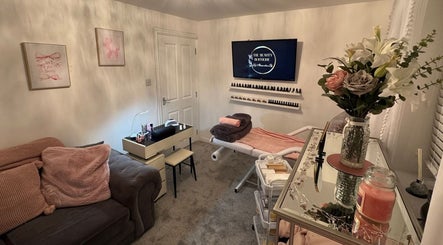 Elegant treatment room at The Beauty Boutique, Plymouth, England, GB with comfy couch and floral decor.