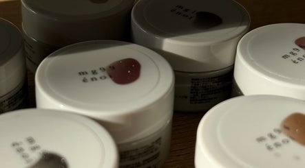 Assorted nail polish pots at Mitts Nails, Edinburgh, Scotland, GB are neatly arranged on a wooden surface.