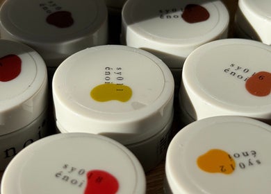 Colorful nail polish caps at mitts nails, Edinburgh, Scotland, GB showcasing vibrant hues.