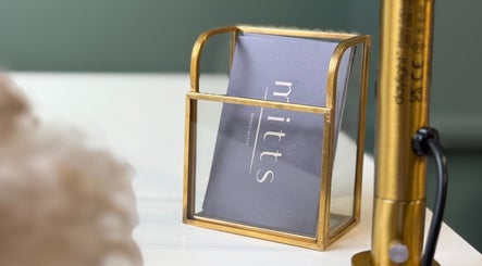 Elegant sign holder displaying Mitts Nails card in Edinburgh, Scotland, GB salon.
