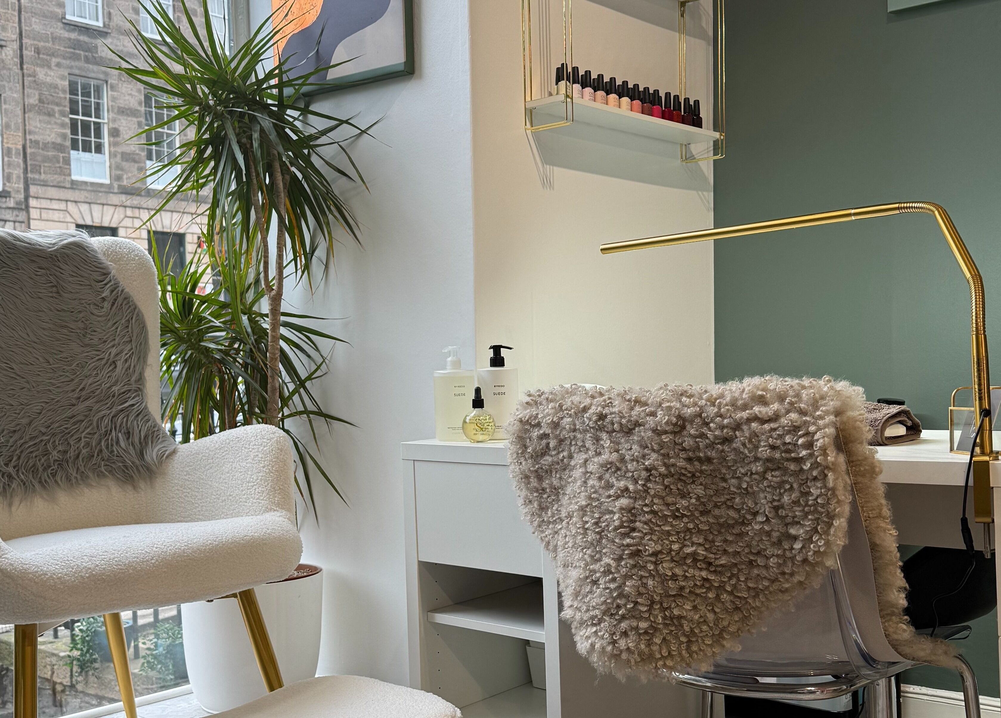 Stylish seating area at Mitts Nails, Edinburgh, Scotland, GB, with modern decor and nail polish display.