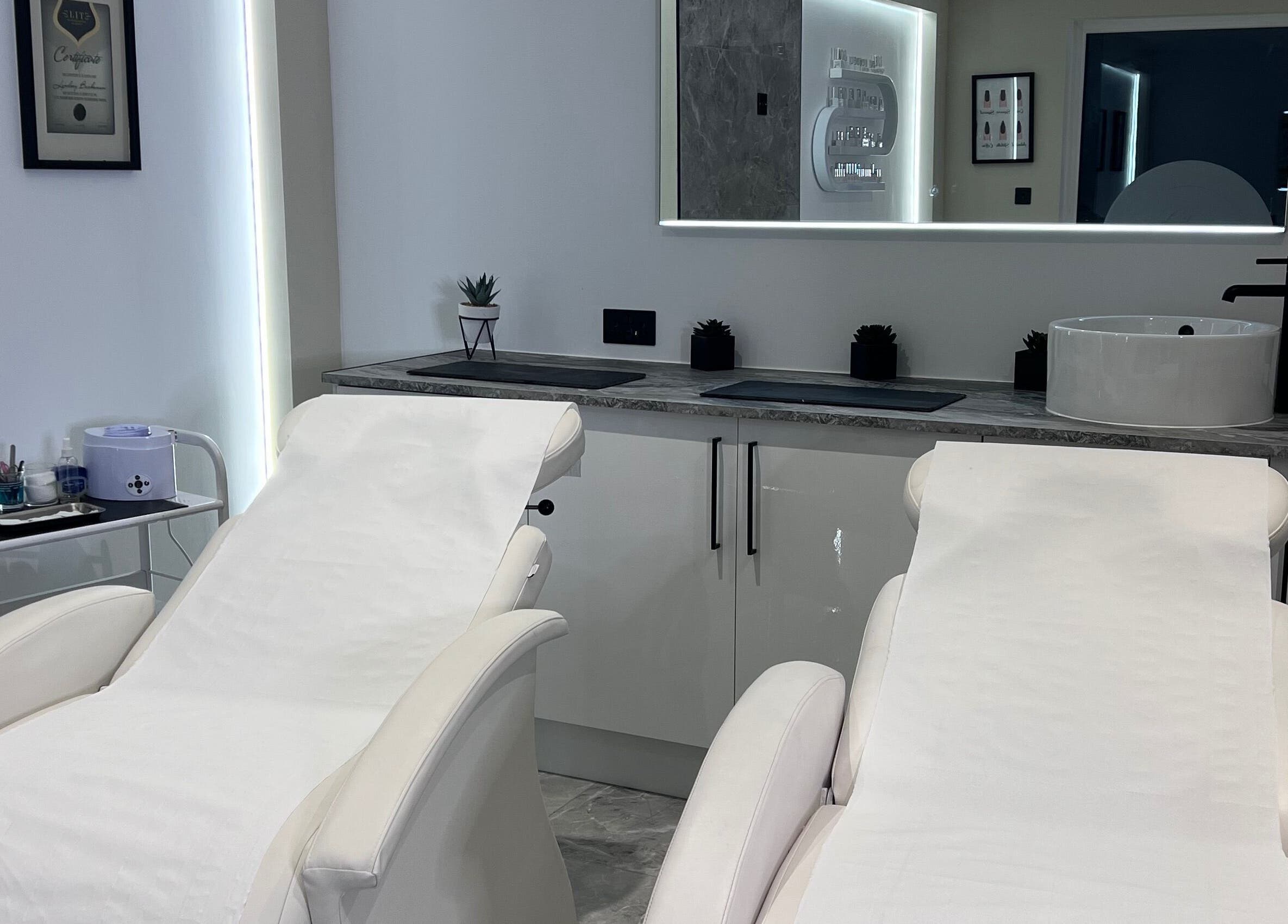 Luxurious treatment room at Beauty Expert Salon & Training, Dennyloanhead, Scotland, GB, featuring plush white chairs.