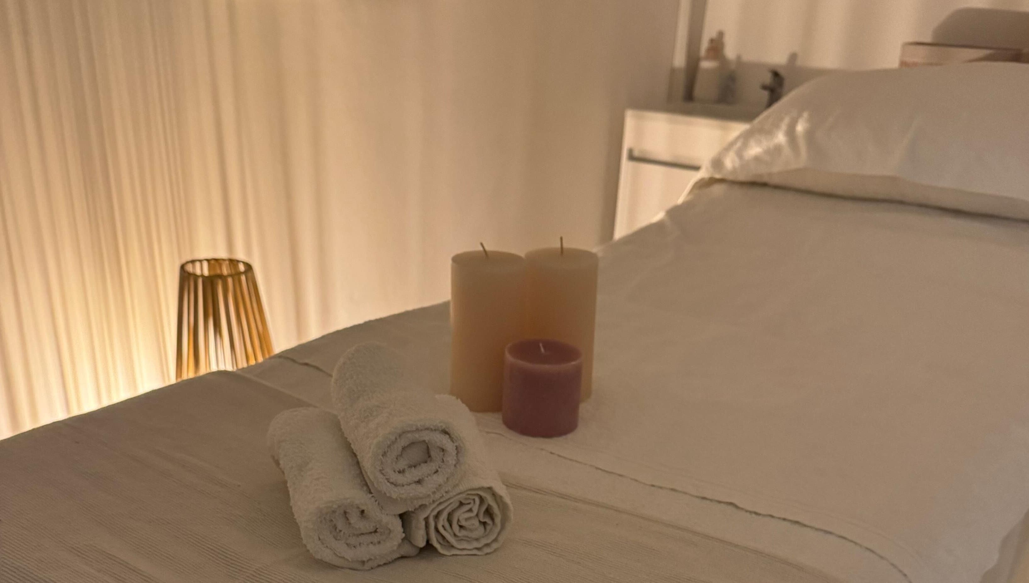 Relaxing spa bed with candles at Skincare By Elena, Cape Town, Western Cape, ZA, offering serene ambiance.