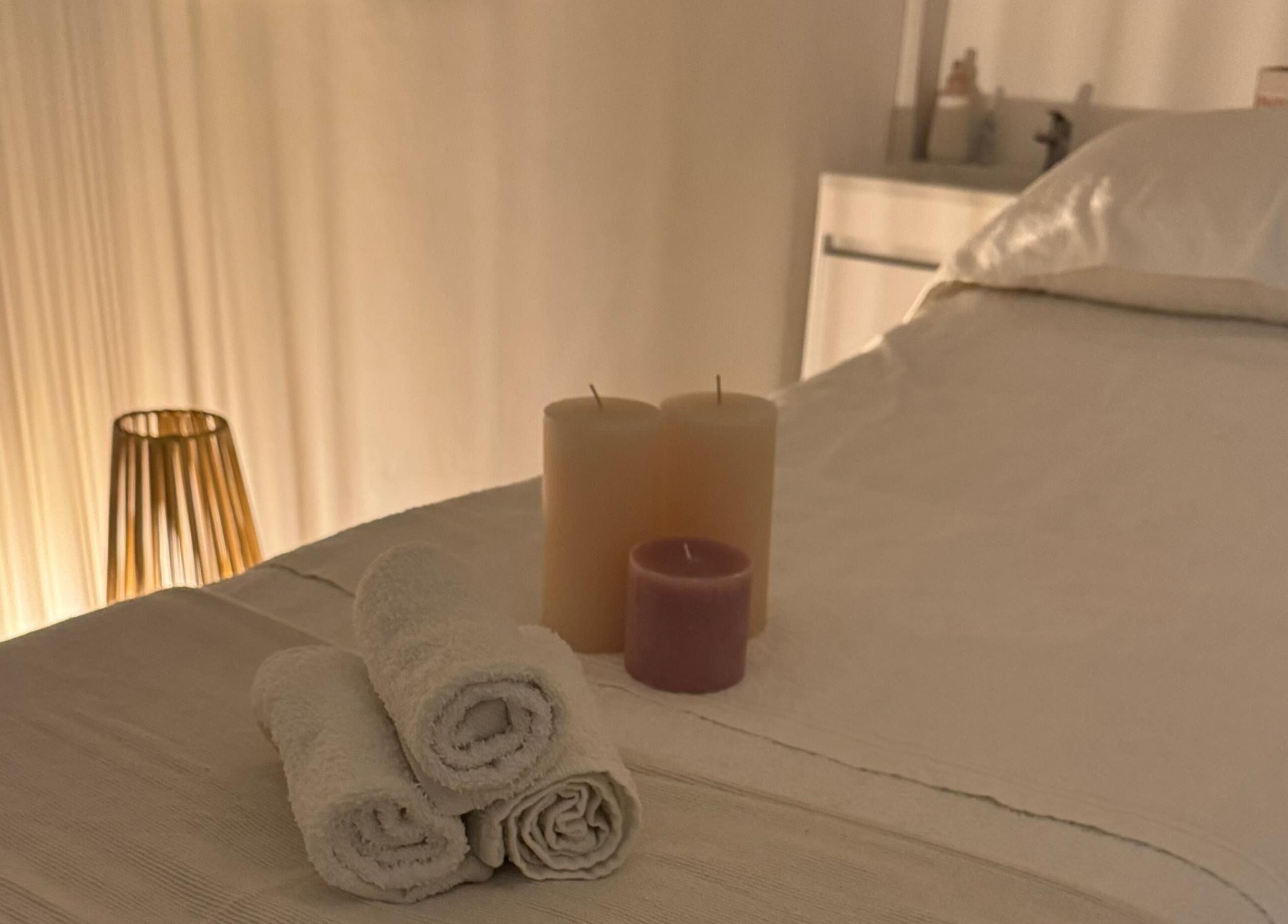 Relaxing spa bed with candles at Skincare By Elena, Cape Town, Western Cape, ZA, offering serene ambiance.