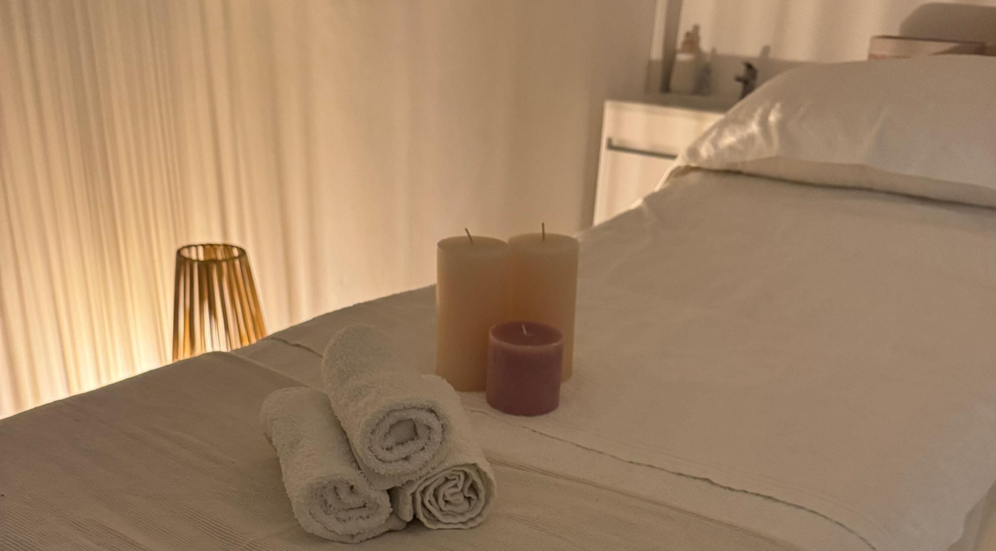 Relaxing spa bed with candles at Skincare By Elena, Cape Town, Western Cape, ZA, offering serene ambiance.