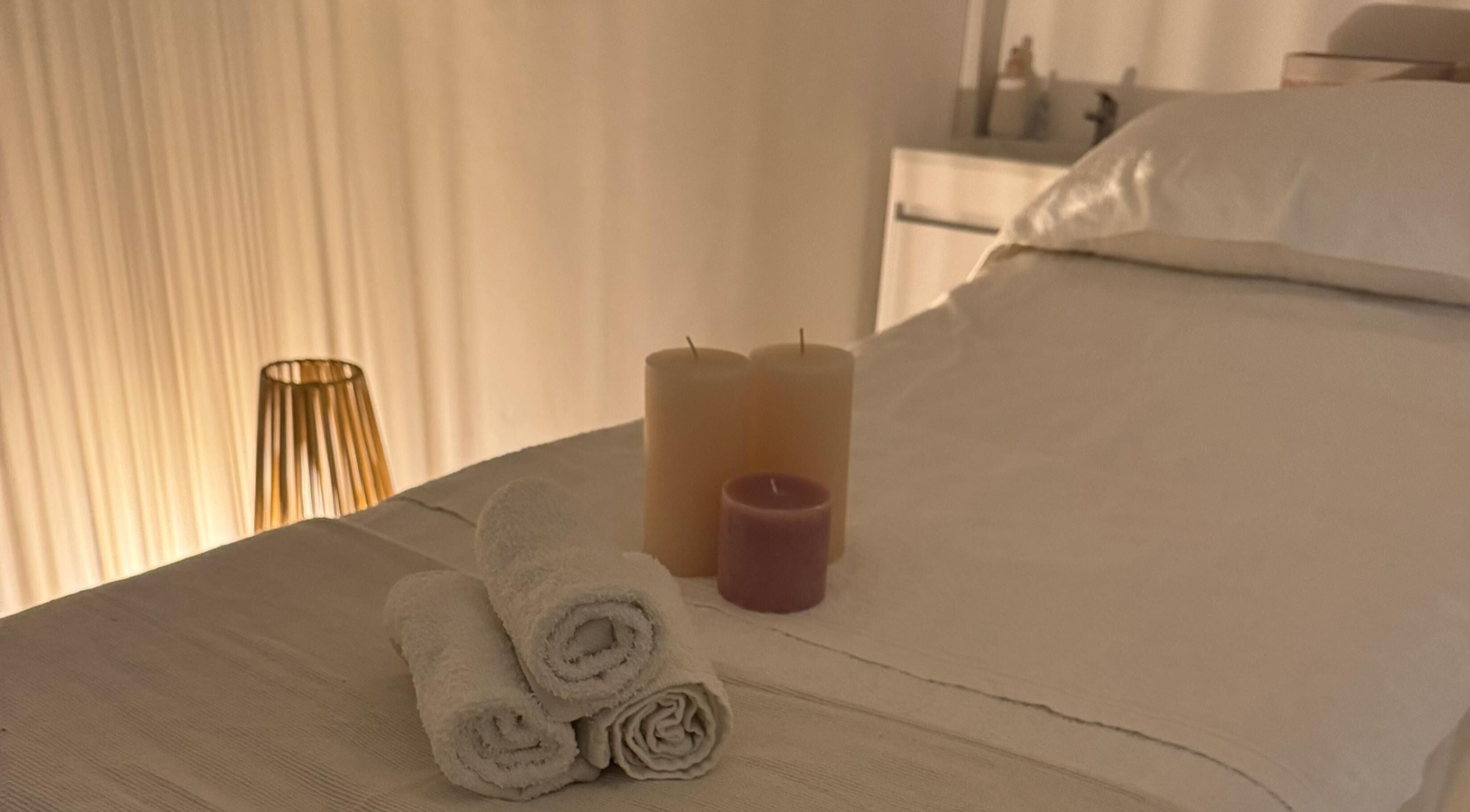 Relaxing spa bed with candles at Skincare By Elena, Cape Town, Western Cape, ZA, offering serene ambiance.
