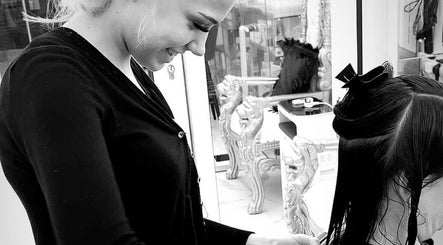 Stylist at Abi Forrester Hair - Mobile creating sleek hairstyle in London, England, GB.