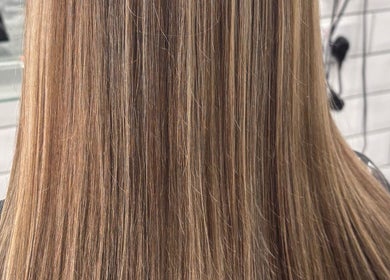 Smooth, straight blonde hair at Abi Forrester Hair - Mobile, London, England, GB.