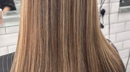 Smooth, straight blonde hair at Abi Forrester Hair - Mobile, London, England, GB.