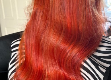 Vibrant red hair styled at Abi Forrester Hair - Mobile. Located in London, England, GB.