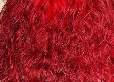 Vibrant red wavy hair styled by Abi Forrester Hair - Mobile in London, England, GB.