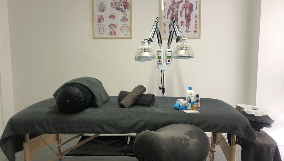Massage table setup at Praktijk Achilles in Capelle Aan Den Ijssel, Zuid-Holland, NL, with wellness supplies.