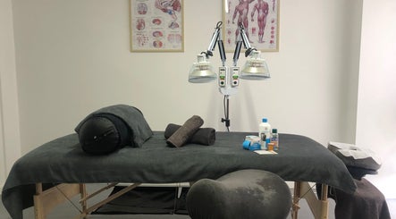 Massage table setup at Praktijk Achilles in Capelle Aan Den Ijssel, Zuid-Holland, NL, with wellness supplies.