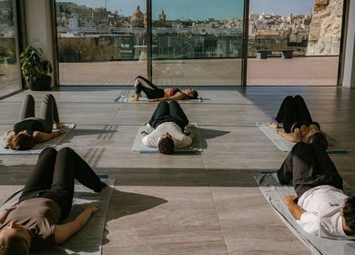Relaxing yoga session at Ray Healing Center, Ta' Xbiex, MT with a scenic city view.