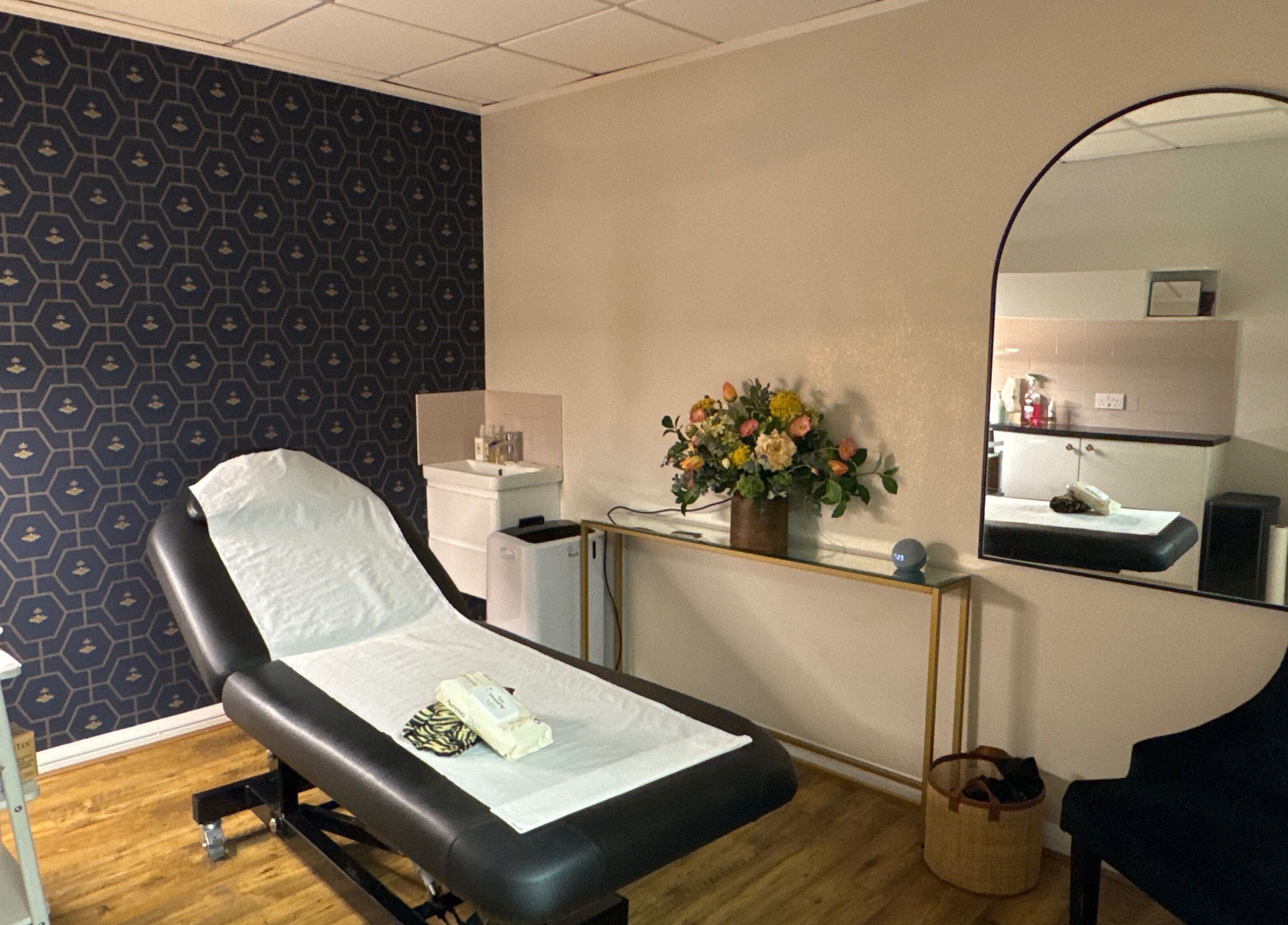 Elegant treatment room at Queen Bee Waxing Studio, Marlow, England, GB, featuring stylish decor and comfortable bed.