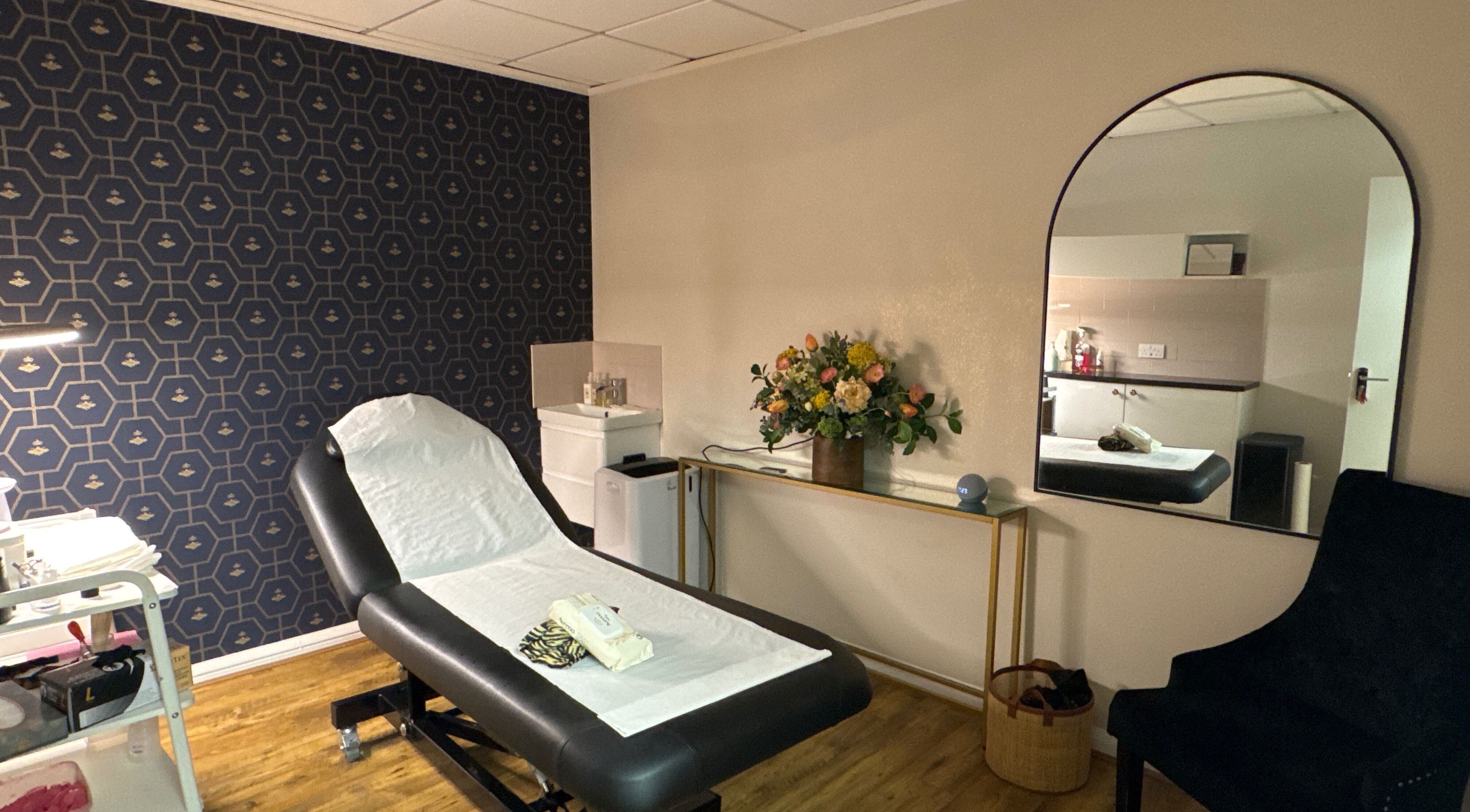 Elegant treatment room at Queen Bee Waxing Studio, Marlow, England, GB, featuring stylish decor and comfortable bed.