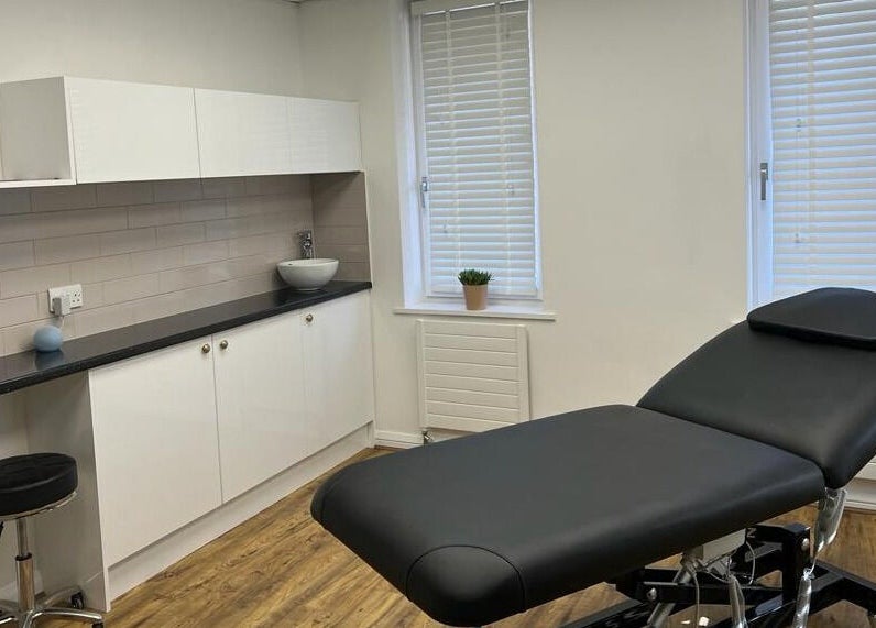 Chic treatment room at Queen Bee Waxing Studio in Marlow, England, GB featuring a modern black massage bed.