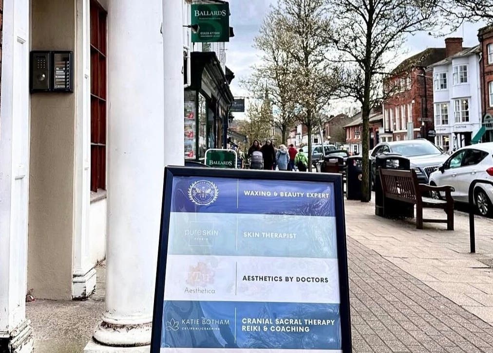 Queen Bee Waxing Studio signage on bustling street in Marlow, England, GB.