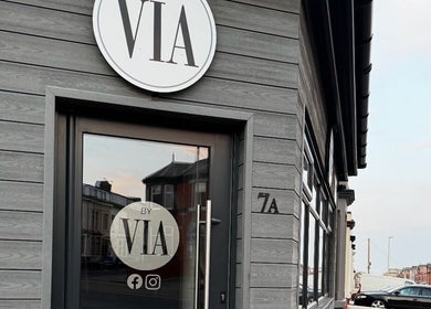 Entrance of REBEL_LASH_CO in Blackpool, England, GB, showcasing a modern grey exterior with logo signage.