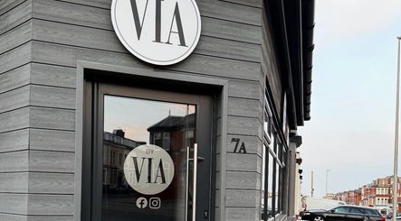 Entrance of REBEL_LASH_CO in Blackpool, England, GB, showcasing a modern grey exterior with logo signage.