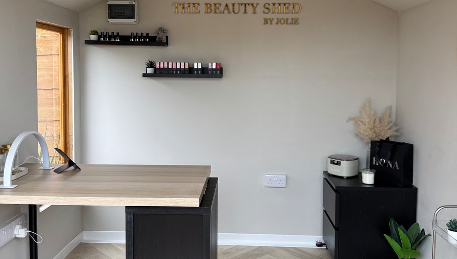 Modern nail treatment area at The Beauty Shed in Shaw, England, GB with sleek design and organized shelves.