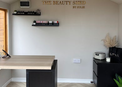 Modern nail treatment area at The Beauty Shed in Shaw, England, GB with sleek design and organized shelves.