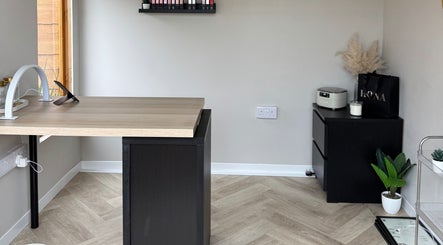 Modern nail salon desk at The Beauty Shed in Shaw, England, GB, showcasing sleek decor and wooden accents.