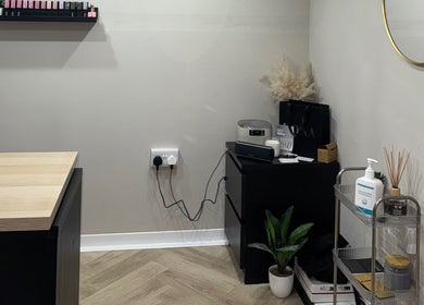 Interior at The Beauty Shed in Shaw, England, GB, featuring a minimalistic setup with wooden accents and greenery.