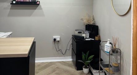 Interior at The Beauty Shed in Shaw, England, GB, featuring a minimalistic setup with wooden accents and greenery.